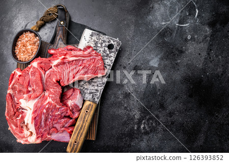 Beautifully marbled raw beef neck meat, perfect for enhancing your favorite recipes with rich flavors. black background. top view Beautifully marbled raw beef neck meat, perfect for enhancing your favorite recipes with rich flavors. black background. top view 126393852