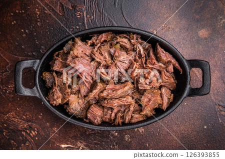 Slow Cooked Pulled Beef, Traditional meat rubbed with spices and smoked. brown background. top view 126393855