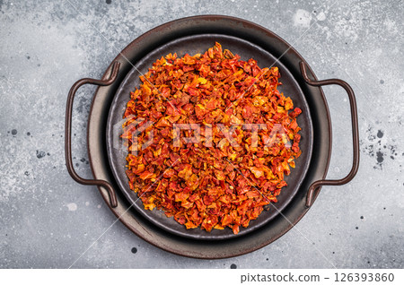 Dried Tomato Flakes, Indian and Arabic spices for cooking. grey background. top view Dried Tomato Flakes, Indian and Arabic spices for cooking. grey background. top view 126393860
