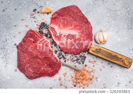 Raw beef cheeks on butcher meat cleaver. grey background. top view 126393863