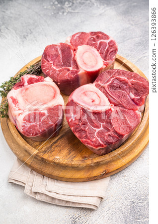 Beautifully marbled raw veal ossobuco, perfect cross cut shank meat for traditional Italian recipes and savory family dinners. white background. top view 126393866