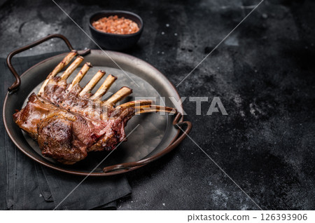 Roast Rack of lamb chops, mutton organic meat. black background. top view Roast Rack of lamb chops, mutton organic meat. black background. top view 126393906
