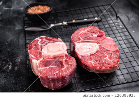 Fresh raw ossobuco Premium veal shank, ideal for slow cooking and creating hearty, comforting meals that impress. black background. top view 126393923