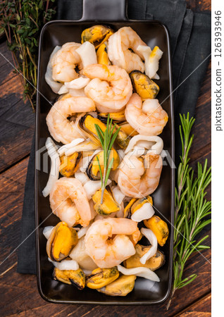 Seafood Cocktail appetiser with Mussels, Clams, Prawns, Shrimps and squid. wooden background. top view Seafood Cocktail appetiser with Mussels, Clams, Prawns, Shrimps and squid. wooden background. top view 126393946