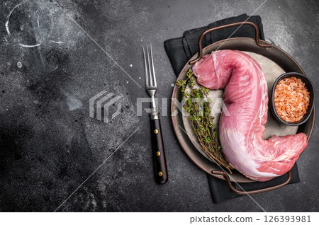Fresh pork tenderloin fillet, showcasing its lean cut, perfect for marinating and grilling to juicy perfection. black background. top view Fresh pork tenderloin fillet, showcasing its lean cut, perfect for marinating and grilling to juicy perfection. black background. top view 126393981