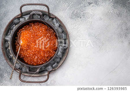 Fresh red caviar, bursting with flavor, perfect for spreading on toast or garnishing your favorite dishes. white background. top view 126393985