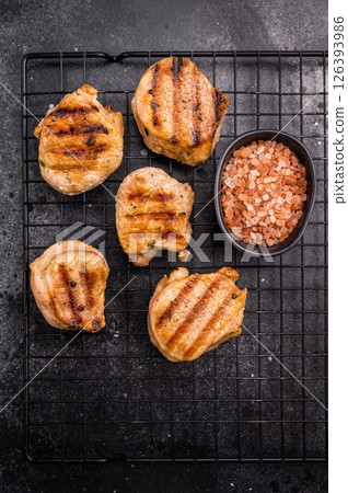 BBQ grilled pork medallions steaks, tenderloin fillet meat. black background. top view BBQ grilled pork medallions steaks, tenderloin fillet meat. black background. top view 126393986