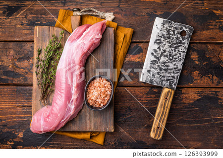Juicy uncooked pork tenderloin, a versatile choice for any culinary creation you have in mind. wooden background. top view 126393999