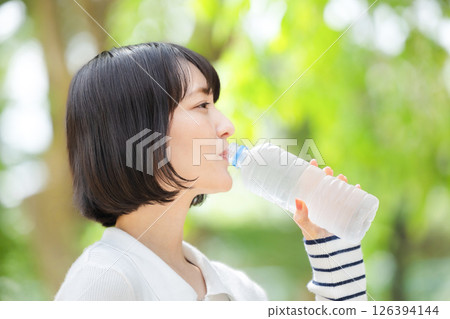 Young woman drinking water Young woman drinking water 126394144