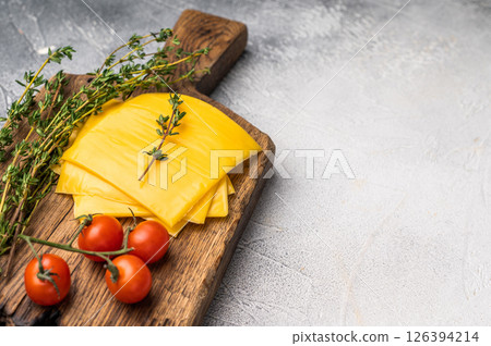 Processed Melted cheese, thin slices for sandwiches. white background. top view Processed Melted cheese, thin slices for sandwiches. white background. top view 126394214