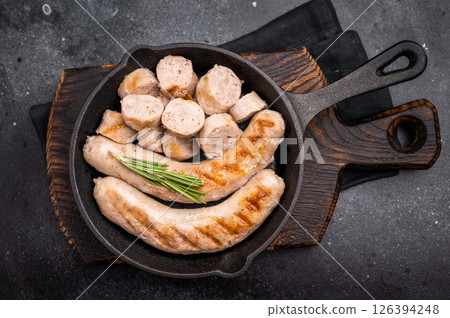 Fried BBQ Sausages with pork and beef meat in pan. black background. top view Fried BBQ Sausages with pork and beef meat in pan. black background. top view 126394248
