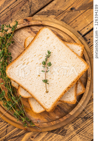 Ready for toasts Slices of wheat bread. wooden background. top view Ready for toasts Slices of wheat bread. wooden background. top view 126394289
