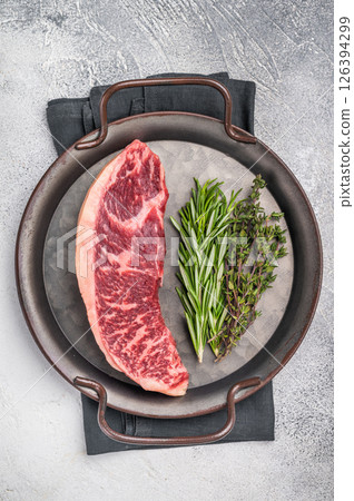 Raw rump cap steak, beef meat, showcasing its rich color and marbling. grey background. top view Raw rump cap steak, beef meat, showcasing its rich color and marbling. grey background. top view 126394299