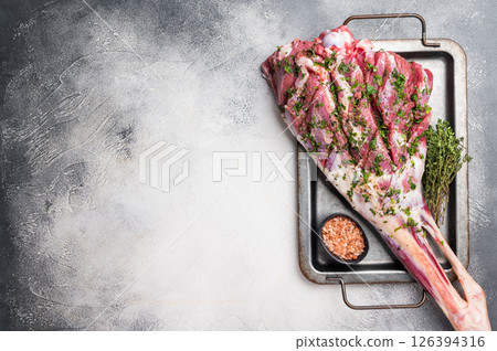 Marinated with herbs and olive oil raw lamb leg. white background. top view 126394316