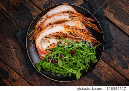 Seafood dinner with Grilled red Shrimps Prawns Langostino Austral on a plate with salad. wooden background. top view 126394317