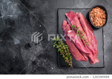 Raw sliced duck breast fillet, uncooked poultry meat. black background. top view Raw sliced duck breast fillet, uncooked poultry meat. black background. top view 126394494