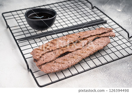 Japanese BBQ yakiniku, grilled wagyu bees strips. grey background. top view 126394498