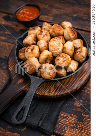 Delicious meatballs, meat patties, showcasing a golden crust and tender interior. isolated on wooden background. top view Delicious meatballs, meat patties, showcasing a golden crust and tender interior. isolated on wooden background. top view 126394510