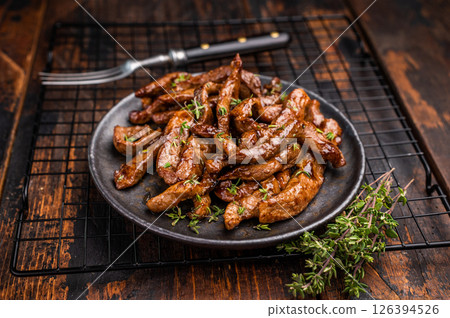 Traditional Asian beef teriyaki with herbs on a plate. wooden background. top view 126394526