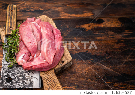 Duck breast fillet, raw sliced poultry meat on butcher board. wooden background. top view 126394527