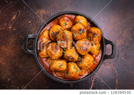Juicy meatballs, perfectly seasoned and beautifully browned, ready to be served with marinara sauce. A classic comfort food that never disappoints. brown background. top view Juicy meatballs, perfectly seasoned and beautifully browned, ready to be served with marinara sauce. A classic comfort food that never disappoints. brown background. top view 126394530