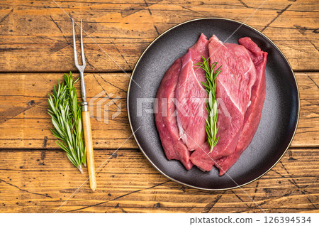 Raw Duck breast fillet slices for stir-fry cooking. wooden background. top view 126394534