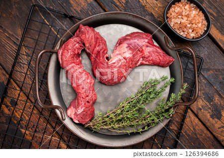Raw Beef Machete Skirt Steak, fresh marble meat with herbs. wooden background. top view 126394686