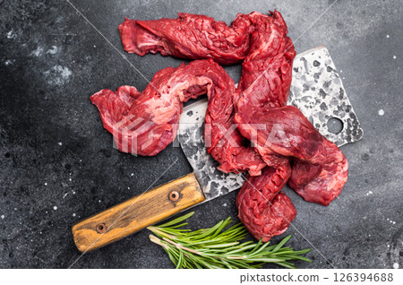 Alternative Beef cut Machete Skirt Steak, raw prime meat on butcher table. black background. top view Alternative Beef cut Machete Skirt Steak, raw prime meat on butcher table. black background. top view 126394688