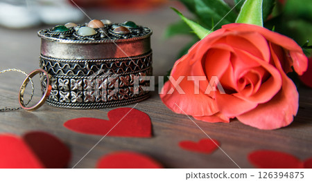 Vintage beautiful gold ring with chain, pink flower, red paper hearts. Vintage composition for Valentines Day or Womens Day.  126394875