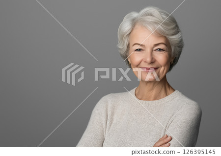A studio portrait of a very elderly woman with a gentle smile, her eyes reflecting decades of wisdom 126395145
