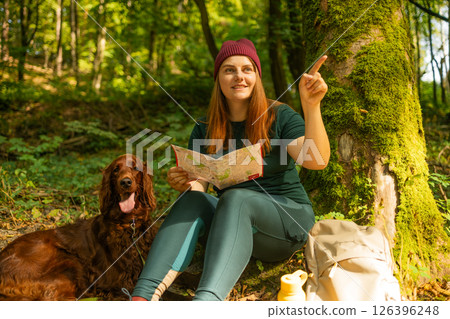 Woman with Map and Dog Resting in Forest Woman with Map and Dog Resting in Forest 126396248