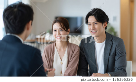 A young couple consulting with a salesman 126396326