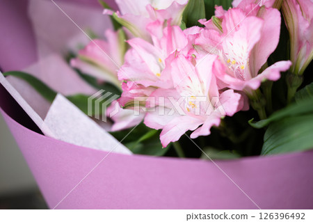 delicate bouquet with pink alstroemerias in wrapping, close-up delicate bouquet with pink alstroemerias in wrapping, close-up 126396492