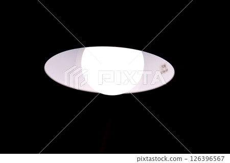 Burning table lamp, contrast, abstraction in the form of a human eye 126396567