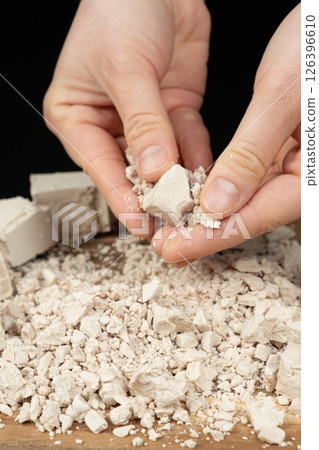 Hands Breaking Fresh Yeast Cube for Baking Preparation. Hands Breaking Fresh Yeast Cube for Baking Preparation. 126396610