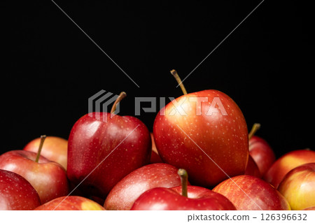 Group of fresh organic red whole apples on a black background. Space for text 126396632