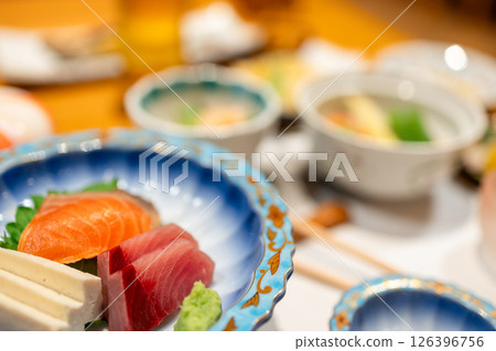 Sashimi plate with tuna, salmon and wasabi in focus during a traditional Japanese kaiseki dinner Sashimi plate with tuna, salmon and wasabi in focus during a traditional Japanese kaiseki dinner 126396756