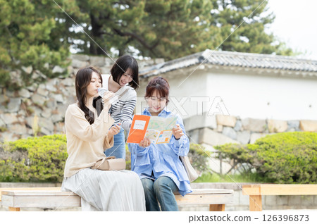 Woman sitting on a bench and taking a break Woman sitting on a bench and taking a break 126396873