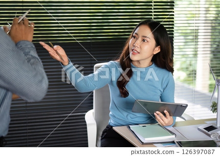 ESG Business Communication. Professional woman discussing renewable energy solutions with colleague. 126397087