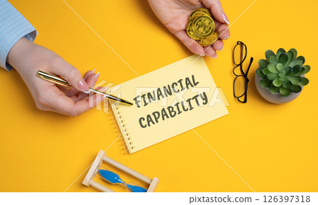Financial capability concept. Knowledge, skills, and confidence to manage money effectively and make informed financial decisions. Woman points to an inscription on a notepad 126397318