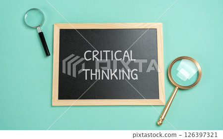 Critical thinking concept. Ability to analyze information objectively and make reasoned judgments based on evidence. Board with inscription and magnifying glass 126397321