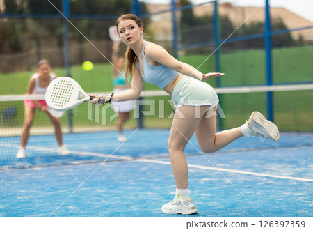 Woman standing on court and playing paddle tennis 126397359