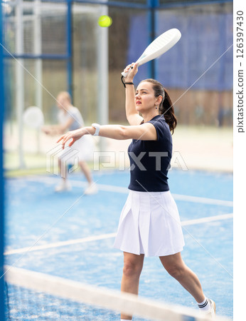 woman participates in a paddle tennis tournament 126397430