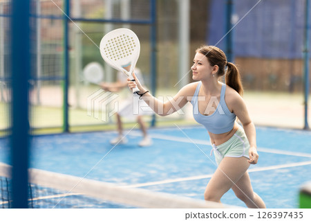 woman participates in a paddle tennis tournament 126397435