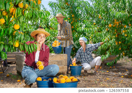 Girl with bunch of peaches 126397558