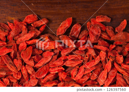 Goji berries on dark wooden background 126397560