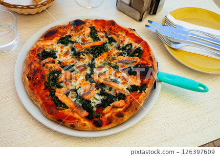 Homemade pizza with salmon slices, spinach and mozzarella 126397609