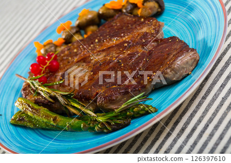 Steak entrecote of beef with mushroom and asparagus at plate Steak entrecote of beef with mushroom and asparagus at plate 126397610