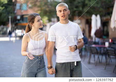 Guy and girl are walking along pedestrian street 126397762