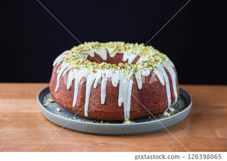 Pistachio Bundt Cake with White Chocolate Glaze on Plate 126398065
